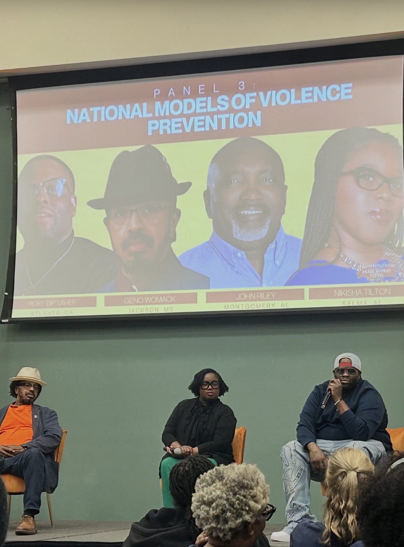Nikesha Tilton seated on the National Models of Violence Prevention panel with two other panelists in front of a projected slide
